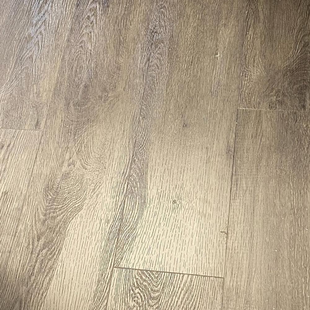 Repaired plank floor with the failed seam closed and the surface finished flat